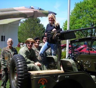Veterans have the coolest toys! - Carey Torrice tries out a machine gun at Freedom Hill during the Stamp Out Hunger Rally.  Carey is seen here with The Chapter 154 Vietnam Veterans of America (better known as her Uncle's)