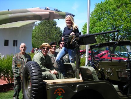 Veterans have the coolest toys! - Carey Torrice tries out a machine gun at Freedom Hill during the Stamp Out Hunger Rally.  Carey is seen here with The Chapter 154 Vietnam Veterans of America (better known as her Uncle's)