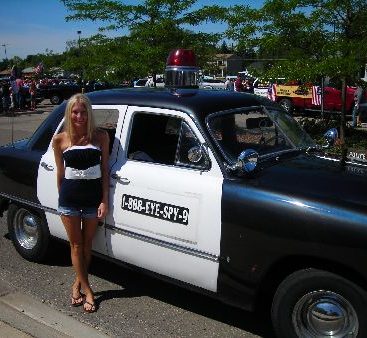 Carey at 4th of July Parade - Carey gets ready for a 4th of July parade in her community. Here she poses next to her 1949 Ford police car.