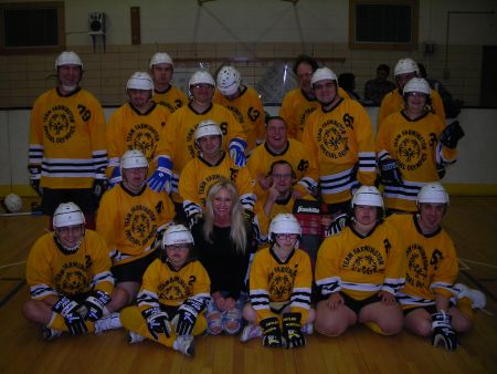 Carey with Team Farmington - Carey poses with Team Farmington Special Olympics hockey team at a game in Farmington