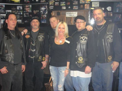 Detroit Vigilante's M/C Charity Fundraiser - Carey poses with her friends from the Detroit Vigilante's Motorcycle Club members at their clubhouse. The Vigilante's M/C hosted a fundraiser to help a five year old child who was mauled by a pit bull. Carey Torrice supported the Vigilante's during this charitable event.  Vigilante's President "Bam Bam" organized this event.