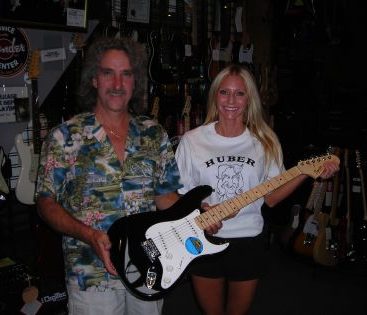 Carey at Huber Breese Music - Carey Torrice accepting a guitar to be signed by The Beach Boys for an Ovarian Cancer Fundraiser